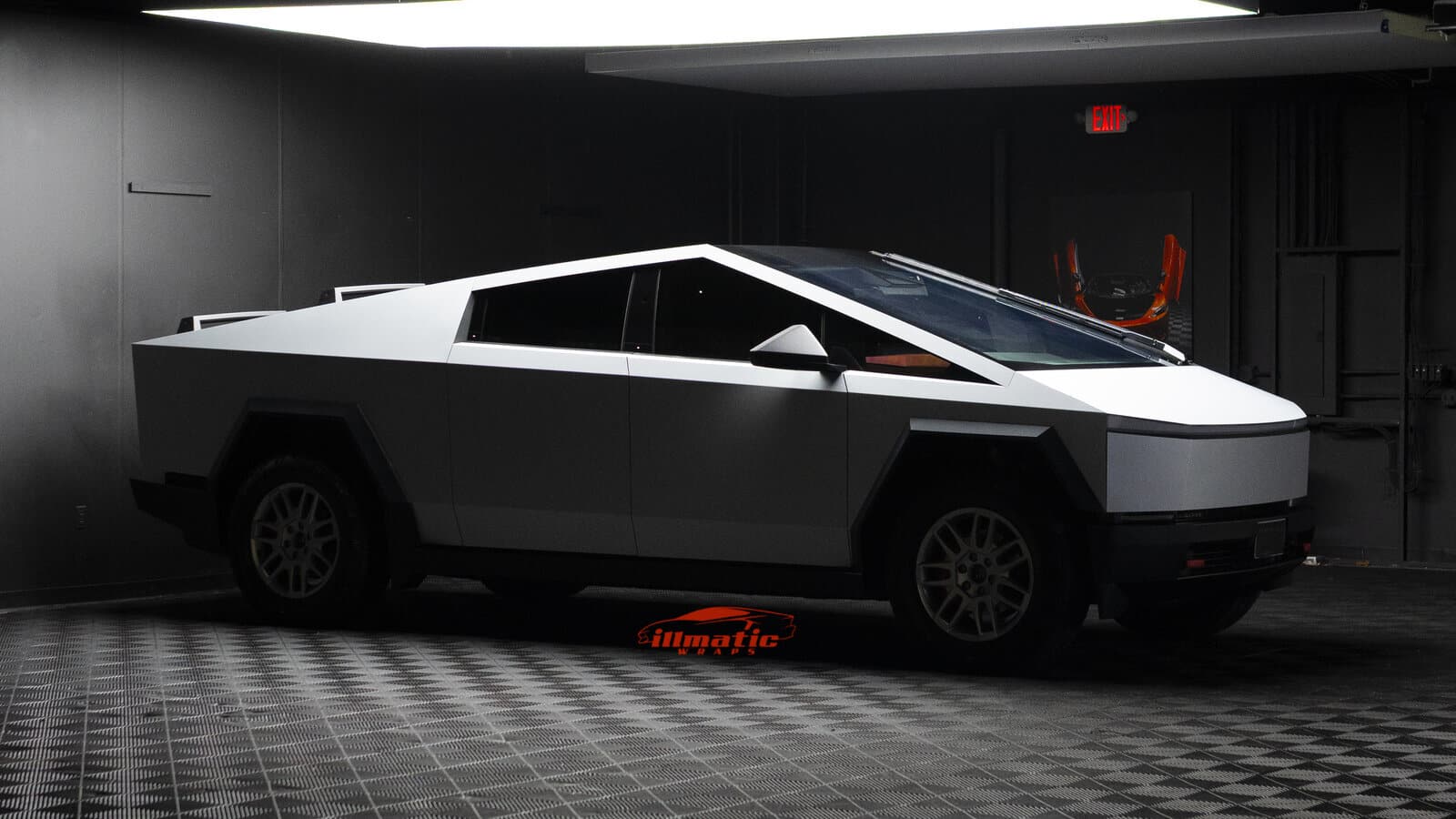 Side view of a matte white wrapped Tesla Cybertruck inside the Illmatic Wraps studio